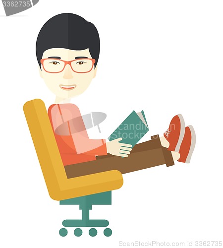 Image of Asian Man sitting with a book