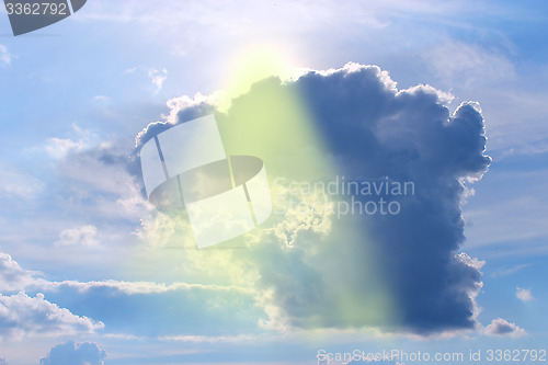 Image of beam of sun fighting through the shaped cloud