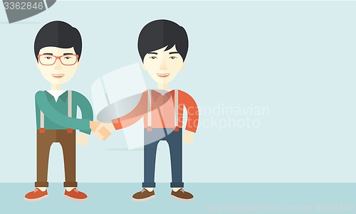 Image of Two asian guys happily handshaking.