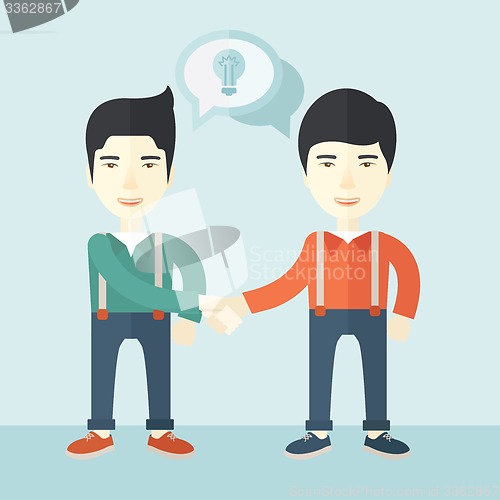 Image of Two asian guys happily handshaking.