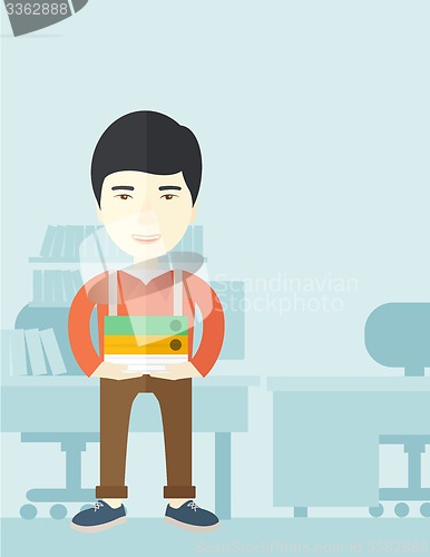 Image of Asian man standing inside his office.