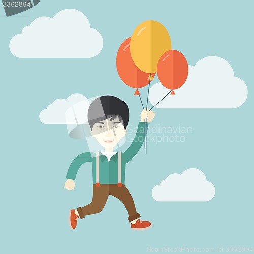 Image of Young japanese man flying with balloons.