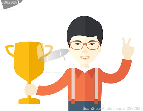Image of Asian man standing while holding his trophy.