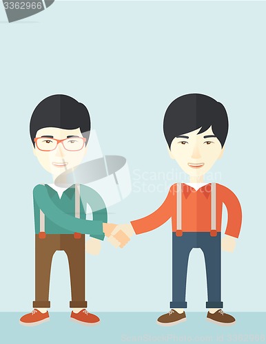 Image of Two asian guys happily handshaking.