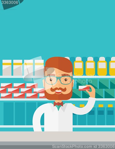 Image of Young  pharmacy chemist man standing in drugstore. 