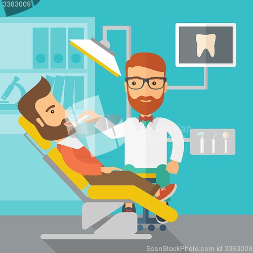 Image of Dentist man examines a patient teeth in the clinic