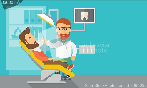 Image of Dentist man examines a patient teeth in the clinic