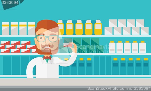 Image of Young  pharmacy chemist man standing in drugstore. 