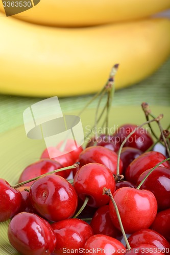 Image of Close up of a fresh pile of fruit consisting of cherries and bananas
