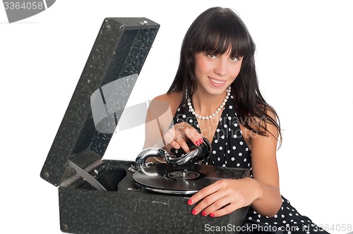 Image of Pretty smiling woman with gramophone