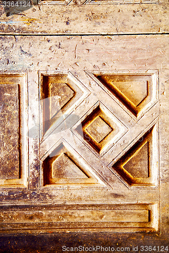 Image of nail   paint in the brown   door and rusty  yellow  