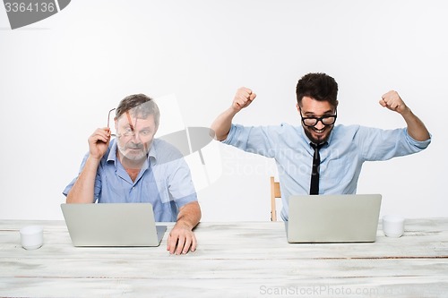 Image of The two colleagues working together at office on white background