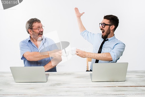 Image of The two colleagues working together at office on white background