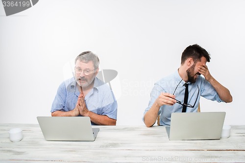 Image of The two colleagues working together at office on white background