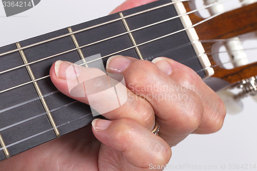 Image of Old hand and guitar isolated