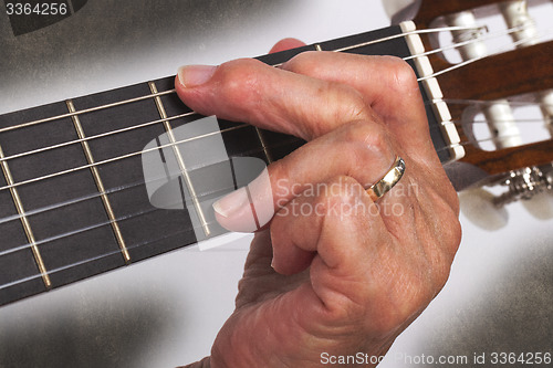 Image of Old hand and guitar isolated