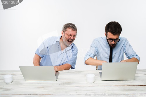 Image of The two colleagues working together at office on white background