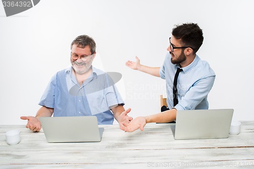 Image of The two colleagues working together at office on white background