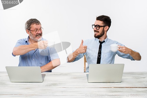 Image of The two colleagues working together at office on white background