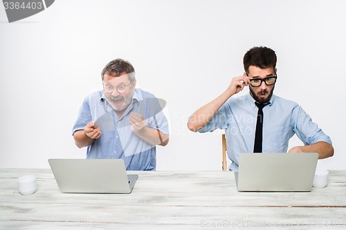 Image of The two colleagues working together at office on white background