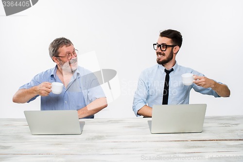 Image of The two colleagues working together at office on white background