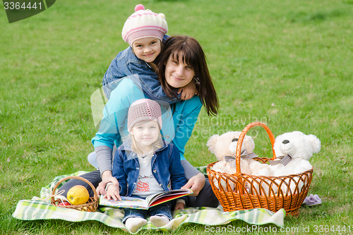 Image of Mother and two daughters on a picnic