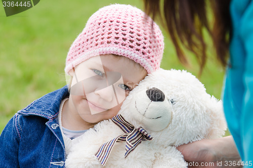 Image of Tired girl lay on a teddy bear