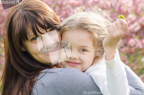 Image of Portrait of mother and daughter on spring background