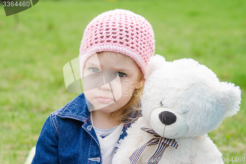 Image of Offended girl with a teddy bear picnic