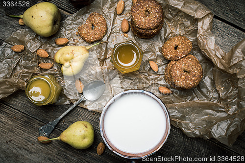 Image of pears Cookies and sour cream on wooden table