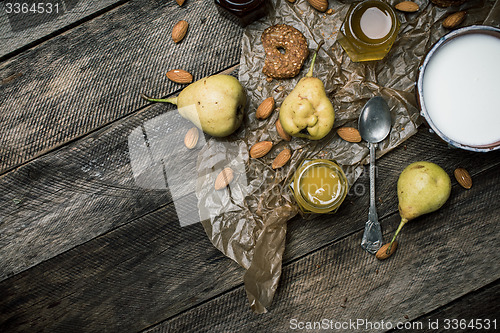 Image of pears Cookies and yoghurt on wooden table