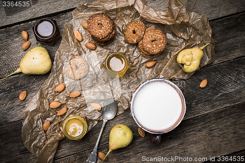 Image of Cookies pears and yoghurt on wooden table