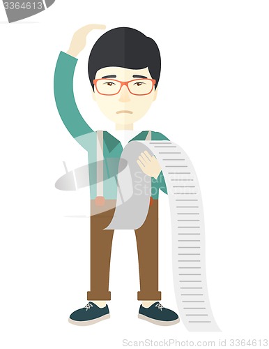 Image of Sad japanese employee holding a list of payables.