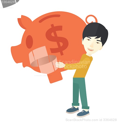 Image of Chinese businessman carries a big piggy bank for saving money.