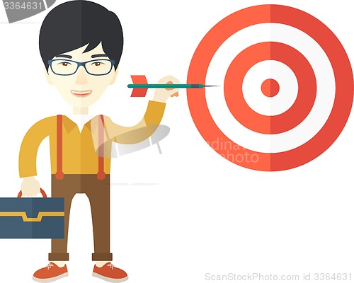 Image of Working chinese man holding a target arrow 