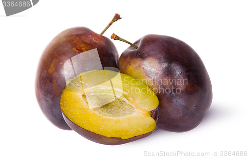 Image of Two violet plums and half
