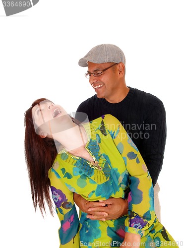 Image of Happy middle age couple joking around.