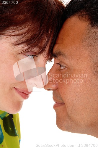 Image of Middle age couple with forehead together.