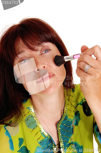 Image of Woman putting makeup on her chic\'s.