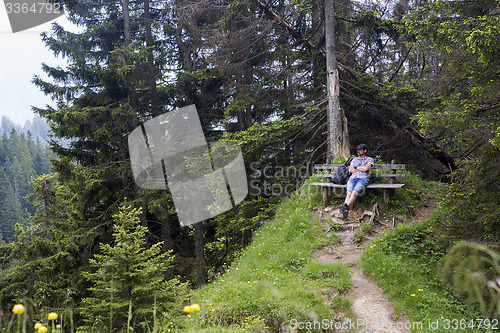 Image of Hiker takes a break and enjoys the view