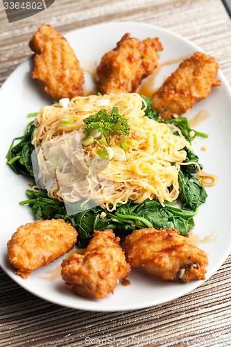 Image of Chicken Wings with Noodles and Spinach