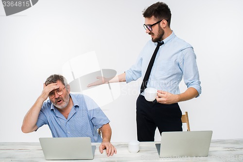 Image of The two colleagues working together at office on white background