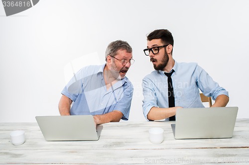 Image of The two colleagues working together at office on white background