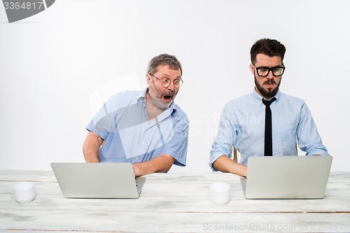 Image of The two colleagues working together at office on white background