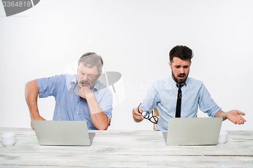 Image of The two colleagues working together at office on white background