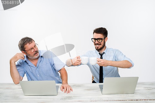 Image of The two colleagues working together at office on white background