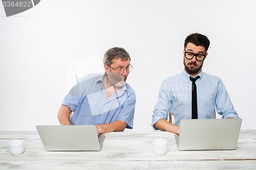 Image of The two colleagues working together at office on white background