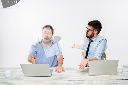 Image of The two colleagues working together at office on white background