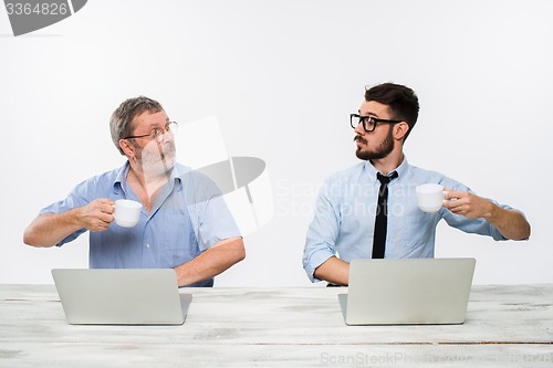 Image of The two colleagues working together at office on white background