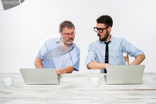 Image of The two colleagues working together at office on white background